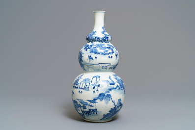 A Chinese blue and white triple gourd vase with circular landscape design, 19th C.