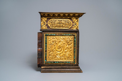 A turquoise-inlaid gilt bronze and copper repouss&eacute; 'tepchog' folding altar table, Tibet, 19th C.