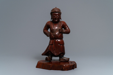 A tall Chinese lacquered wood figure of a guardian, 19th C.