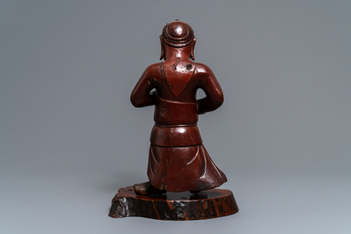 A tall Chinese lacquered wood figure of a guardian, 19th C.
