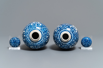 A pair of Chinese olive-shaped blue and white covered jars, Kangxi