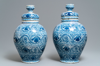 A pair of large Dutch Delft blue and white vases and covers, 18th C.