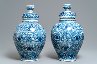 A pair of large Dutch Delft blue and white vases and covers, 18th C.