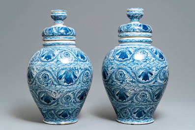 A pair of large Dutch Delft blue and white vases and covers, 18th C.