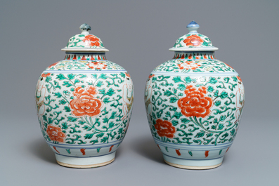 A pair of Chinese wucai vases and covers with boys among peonies, Transitional period