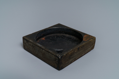 A square Chinese inscribed wood-encased duan inkstone, 19/20th C.