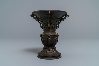 A Chinese relief-decorated bronze 'gu' vase with inscribed base, 18/19th C.
