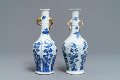 A pair of Chinese blue and white vases with parcel-gilt handles, Kangxi