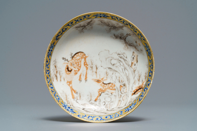 A Chinese grisaille and iron red cup and saucer with deer, Yongzheng/Qianlong