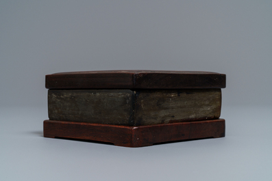 A square Chinese inscribed wood-encased duan inkstone, 19/20th C.