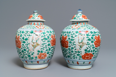 A pair of Chinese wucai vases and covers with boys among peonies, Transitional period