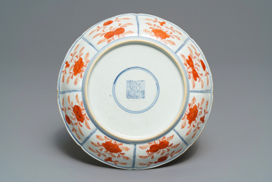 Een Chinees blauw-wit en ijzerrood bord met tempelleeuwen, Qianlong merk, 18/19e eeuw