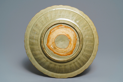 A Chinese Longquan celadon dish with incised floral design, early Ming