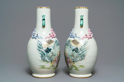 A pair of Chinese famille rose vases with figures in a landscape, 19/20th C.