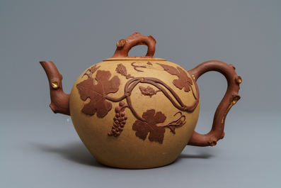 A large Chinese Yixing stoneware teapot with applied grape vines design, Kangxi