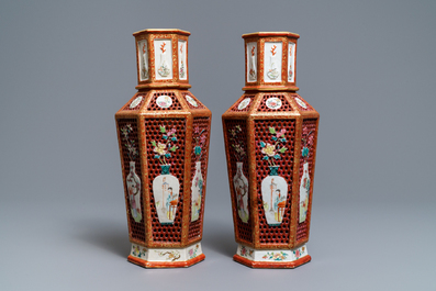 A pair of Chinese reticulated double-walled hexagonal famille rose vases, Yongzheng