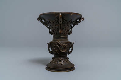 Een Chinese bronzen 'gu' vaas met reli&euml;fdecor met inscriptie, 18/19e eeuw