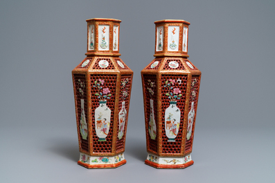 A pair of Chinese reticulated double-walled hexagonal famille rose vases, Yongzheng