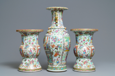 A pair of Chinese Canton famille rose spittoons and a vase, 19th C.