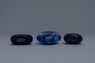 Three Chinese transparent blue glass snuff bottles, one inscribed, 18/19th C.