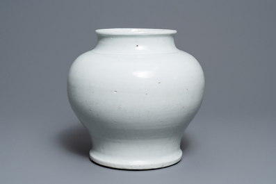 A Chinese monochrome white vase with a wooden cover and stand, Ming