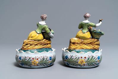 A pair of polychrome Dutch Delft butter tubs with ladies selling flowers and fruits, 18th C.