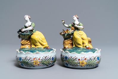 A pair of polychrome Dutch Delft butter tubs with ladies selling flowers and fruits, 18th C.