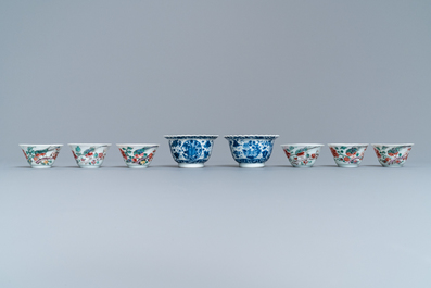 Eight Chinese blue and white and famille rose cups and saucers and three plates, Kangxi/Qianlong