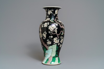 A Chinese famille noire 'magpie and prunus' vase, Kangxi