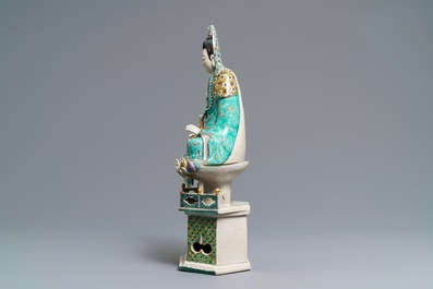 A Chinese verte biscuit group of Guanyin with child on a lotus throne, Kangxi