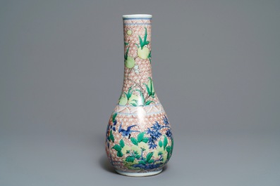A Chinese wucai bottle vase with birds in a garden, Transitional period