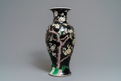 A Chinese famille noire 'magpie and prunus' vase, Kangxi