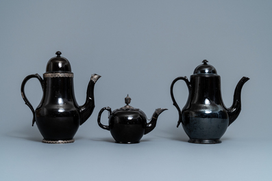 Four silver-mounted Namur black-glazed pottery coffeepots and a teapot, 18th C.