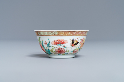 A fine Chinese famille rose cup and saucer with flowers and insects, Yongzheng