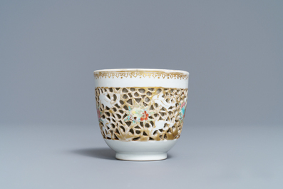 A reticulated Chinese famille rose cup and saucer, Qianlong