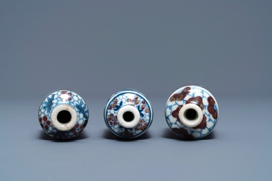 Three Chinese blue, white and underglaze red snuff bottles, Yongzheng marks, 19th C.