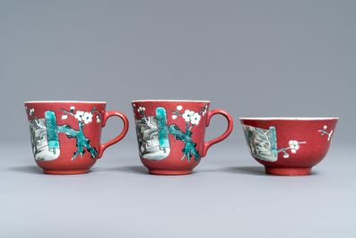 A Chinese famille rose ruby-ground teapot, three cups and two saucers, Yongzheng