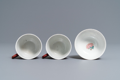 A Chinese famille rose ruby-ground teapot, three cups and two saucers, Yongzheng