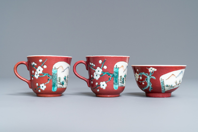 A Chinese famille rose ruby-ground teapot, three cups and two saucers, Yongzheng