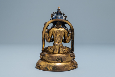 A Sino-Tibetan inlaid gilt bronze figure of Buddha, Ming