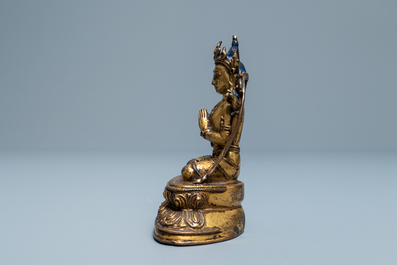 A Sino-Tibetan inlaid gilt bronze figure of Buddha, Ming