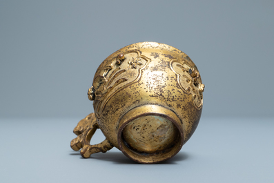 A Chinese relief-decorated gilt bronze cup, Ming