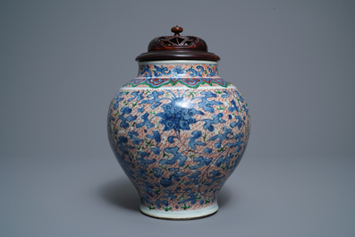 A Chinese wucai 'lotus scroll' jar with wooden cover and stand, Transitional period