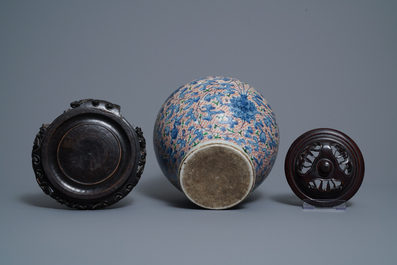 A Chinese wucai 'lotus scroll' jar with wooden cover and stand, Transitional period