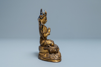 A Sino-Tibetan inlaid gilt bronze figure of Buddha, Ming