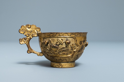 A Chinese relief-decorated gilt bronze cup, Ming