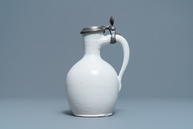 A white Dutch Delft jug with pewter cover, 17th C.