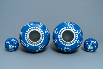A pair of Chinese blue and white 'prunus on cracked ice' jars and covers, 19th C.