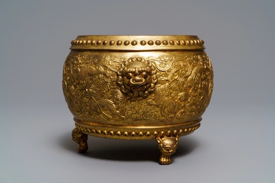 A Chinese gilt bronze tripod censer with buddhist lions, Qianlong mark, 19/20th C.