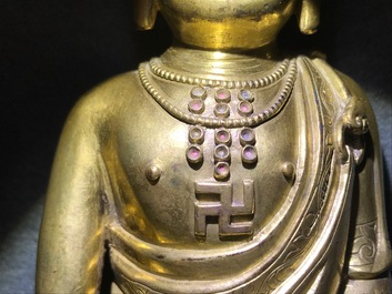 An inscribed Chinese gilt bronze figure of Buddha standing, Qianlong